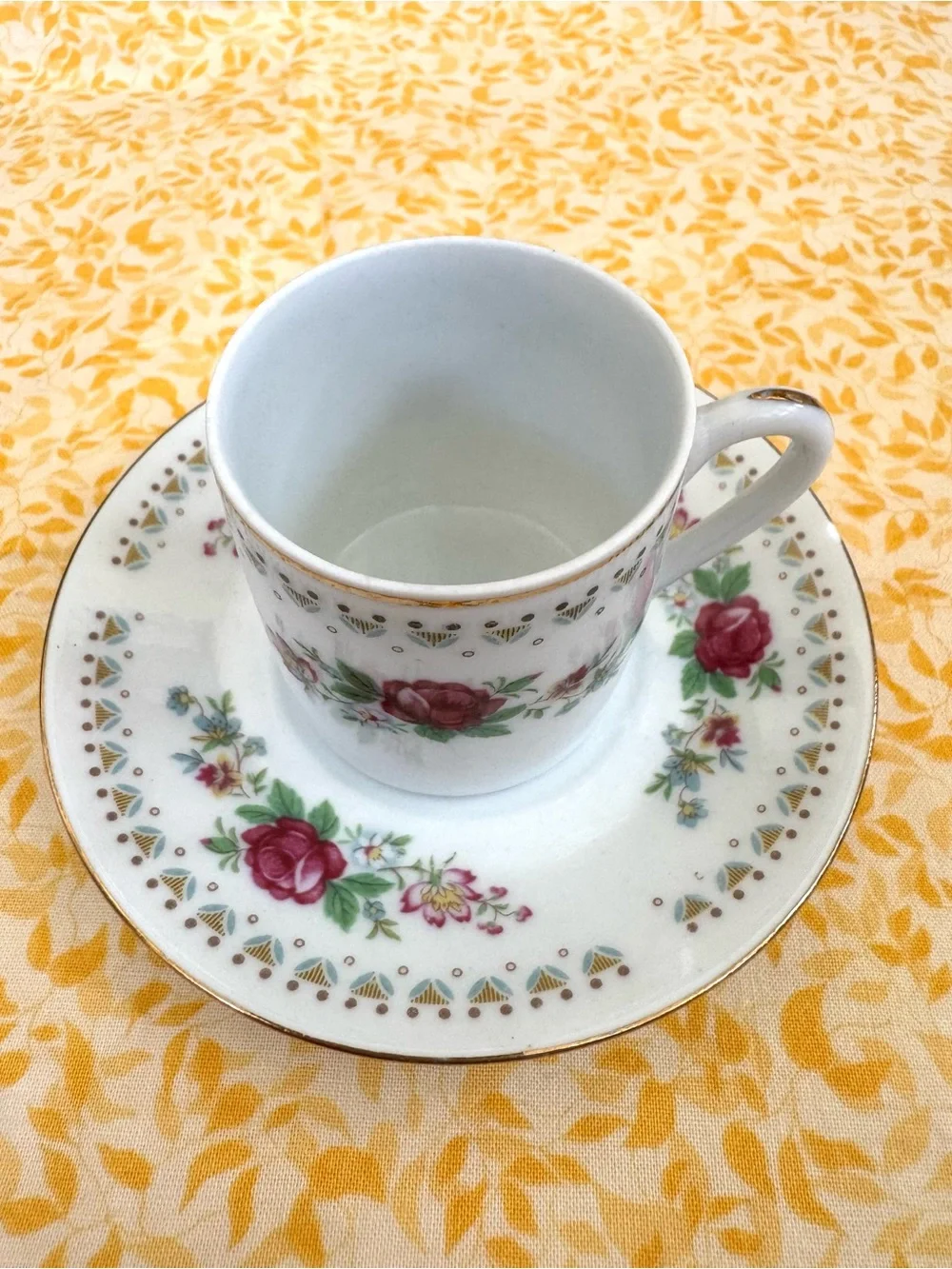 Vintage Espresso Cup and Matching Saucer. White Porcelain with Floral Motif.